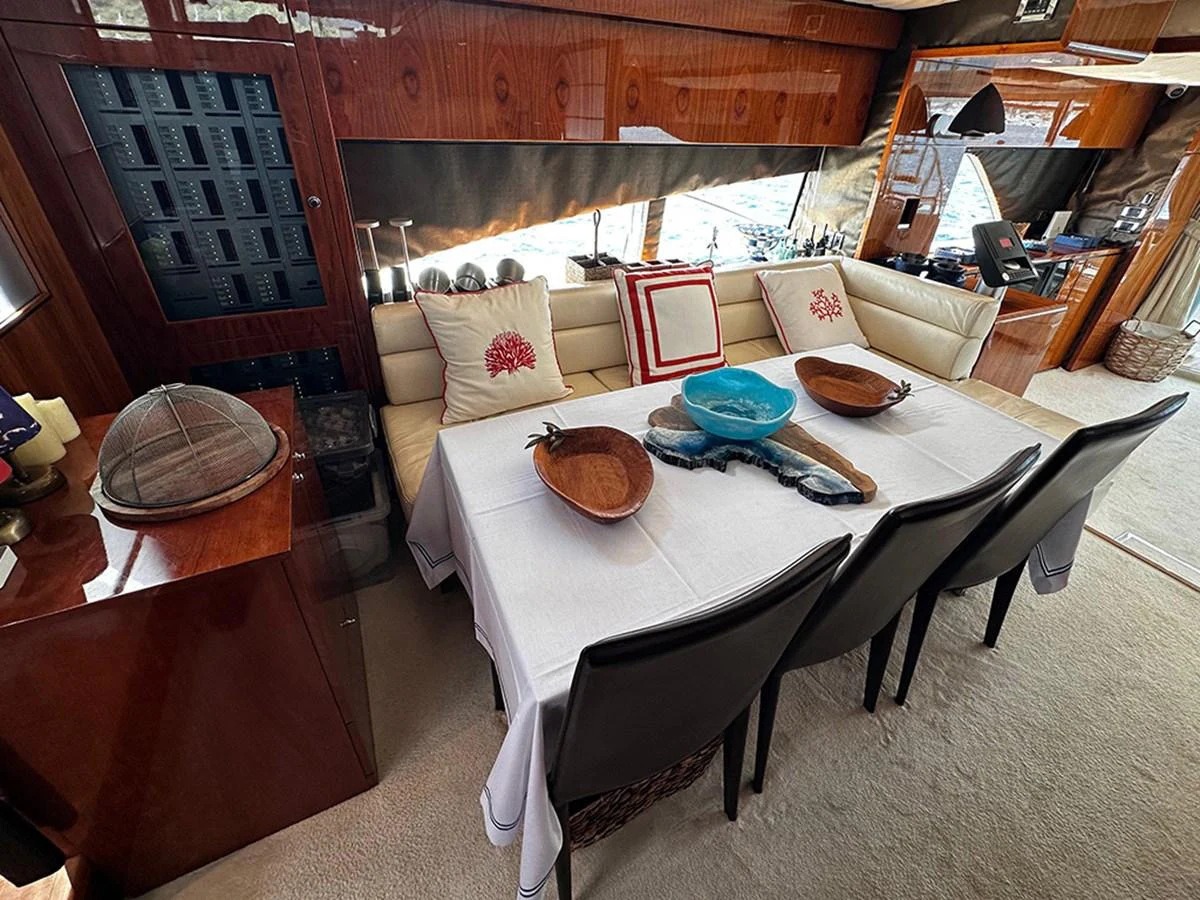 The yacht's dining area features a stylish table set with elegant decor and comfortable seating. aboard SEDEF Yacht for Sale
