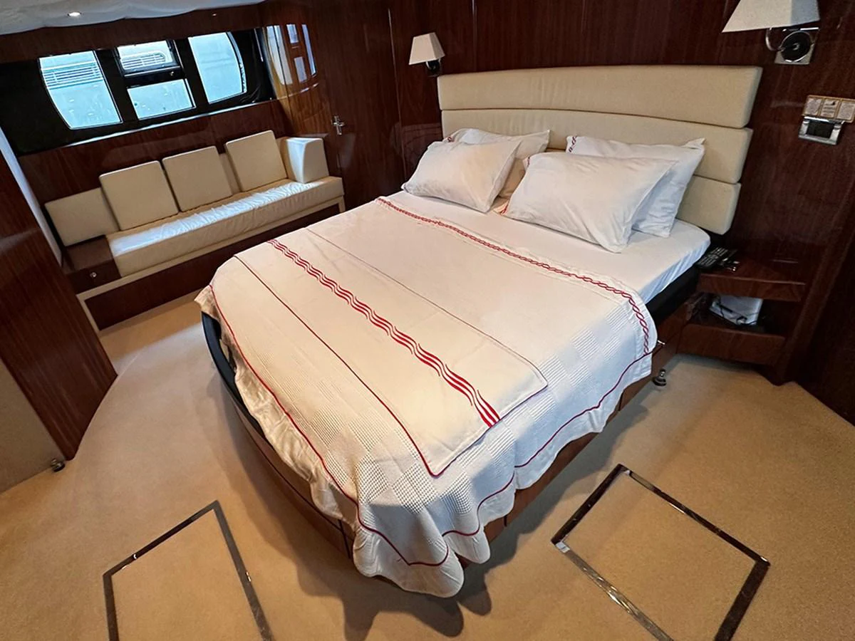 A luxurious stateroom featuring a comfortable bed and elegant wood paneling. aboard SEDEF Yacht for Sale