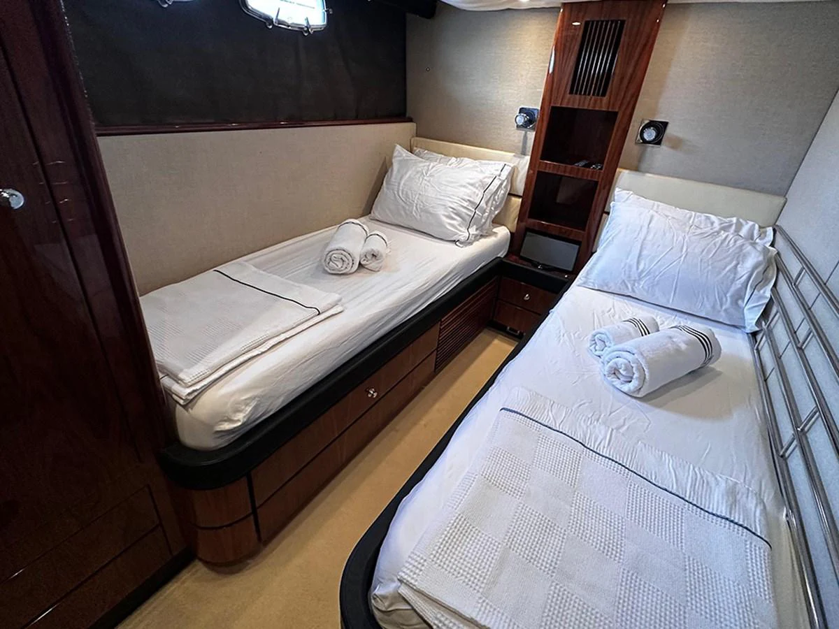 The twin stateroom offers cozy and comfortable sleeping arrangements with neatly made beds and soft lighting. aboard SEDEF Yacht for Sale