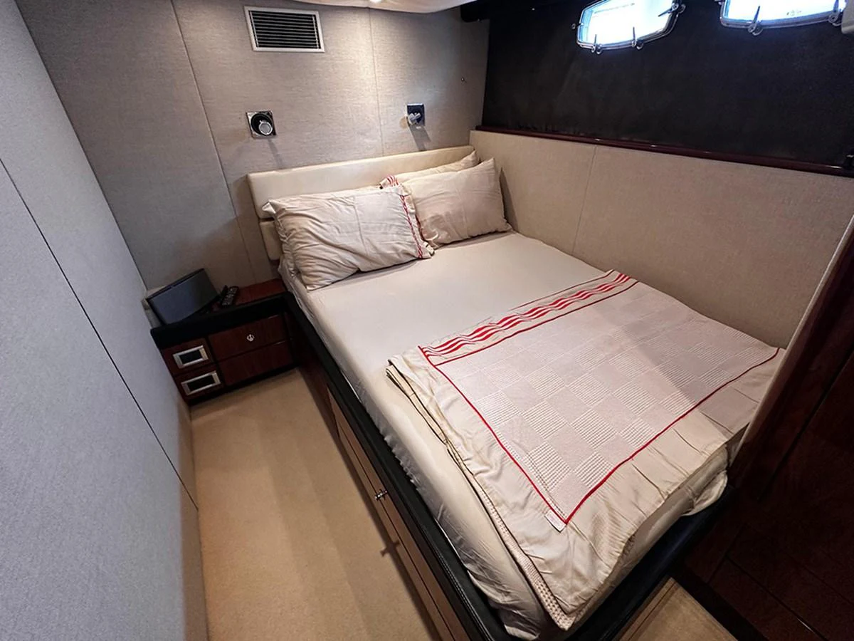 A cozy stateroom featuring a comfortable double bed with elegant bedding and soft lighting. aboard SEDEF Yacht for Sale
