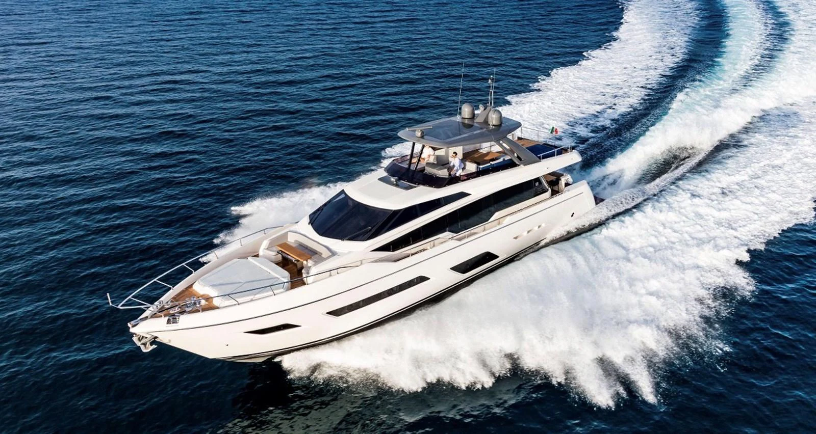 A sleek and modern yacht cruises swiftly through the open water, leaving a trail of white waves behind. aboard LD Yacht for Sale