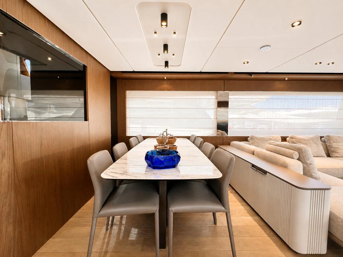 The yacht's dining area features a sleek table with comfortable seating, perfect for elegant meals on board. aboard LD Yacht for Sale