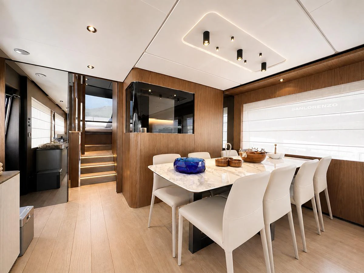 The yacht's dining area features a sleek, modern design with a marble table and comfortable seating. aboard LD Yacht for Sale