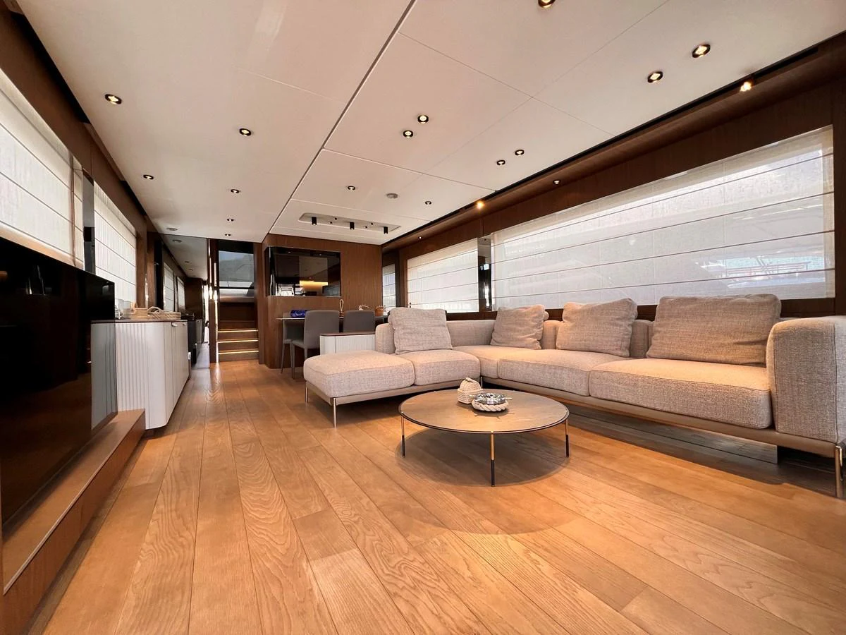 The salon features a spacious and elegantly designed seating area with modern furnishings and ample natural light. aboard LD Yacht for Sale