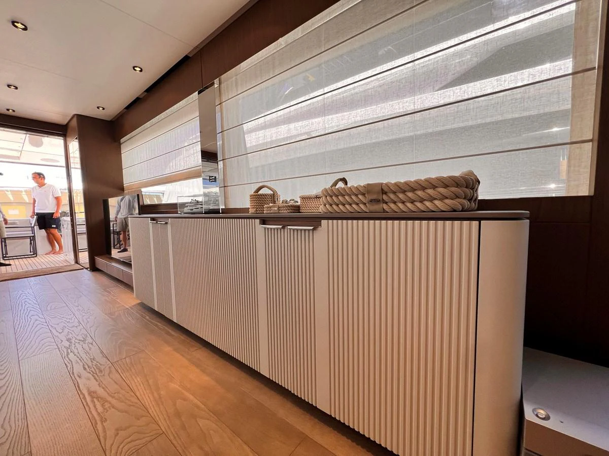 The interior showcases a modern design with sleek cabinetry and natural light. aboard LD Yacht for Sale