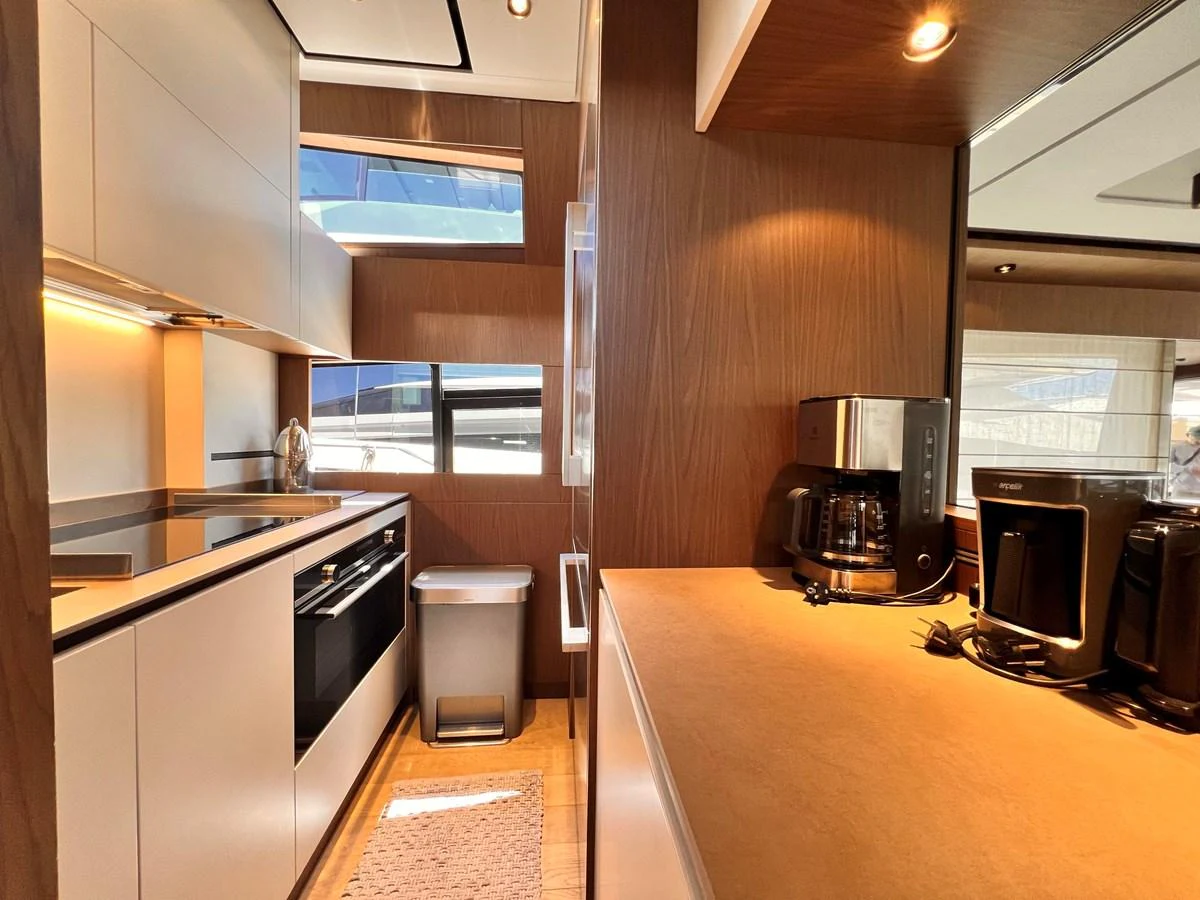 The yacht's galley is modern and well-equipped with sleek appliances and ample counter space. aboard LD Yacht for Sale