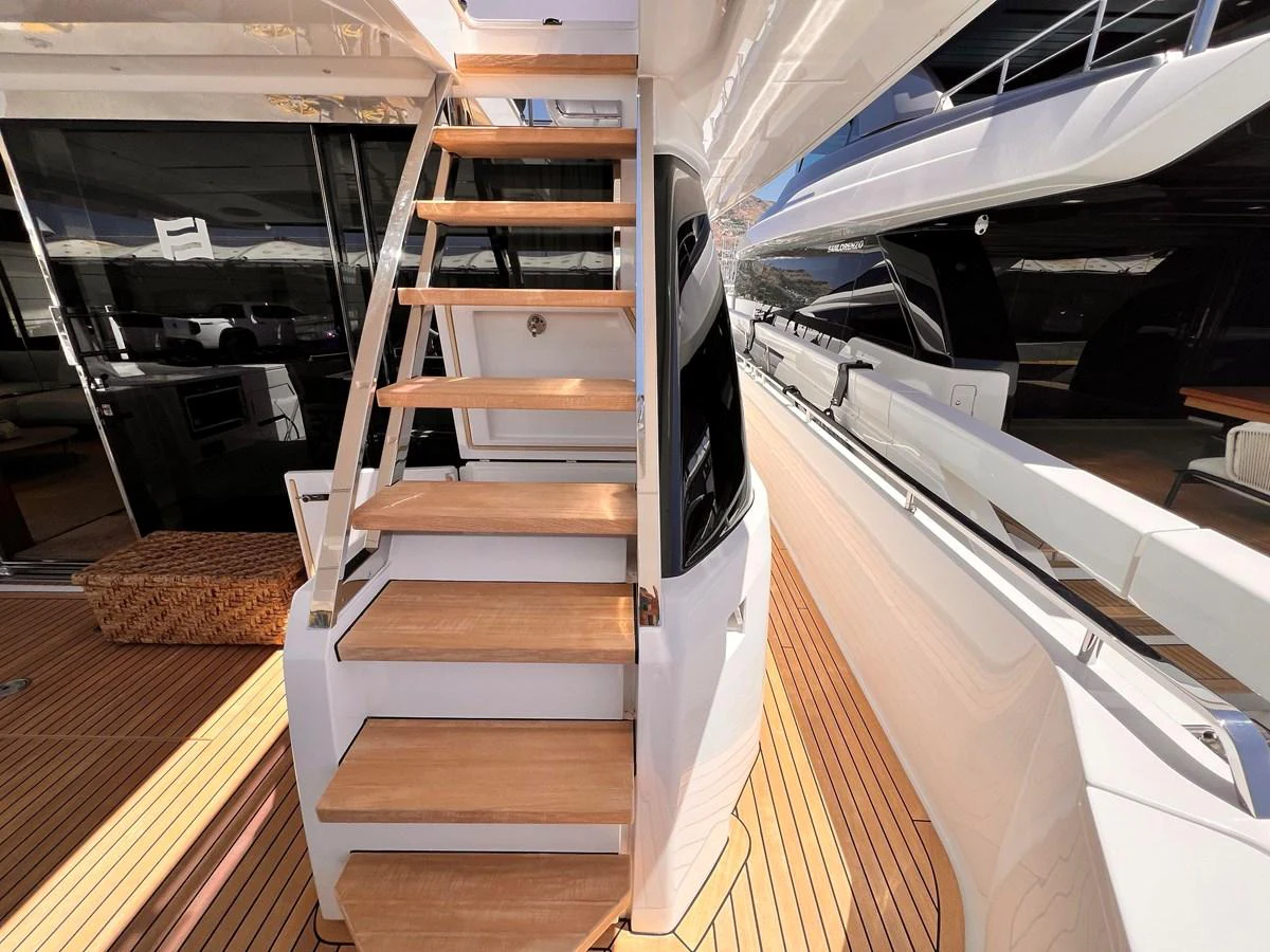 A close-up view of the yacht's exterior staircase leading to the upper deck. aboard LD Yacht for Sale