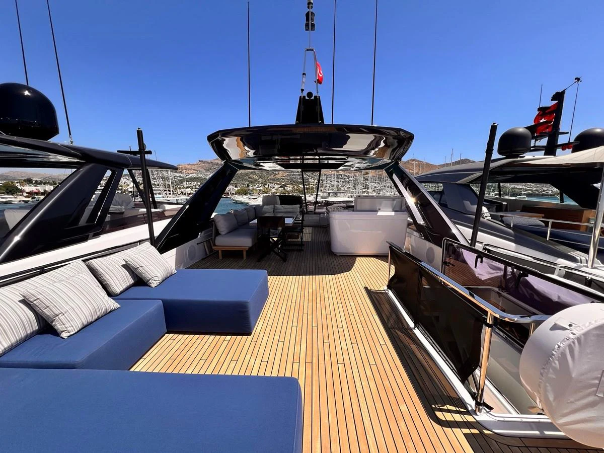 The spacious flybridge offers ample seating and lounging areas under a sleek canopy. aboard LD Yacht for Sale