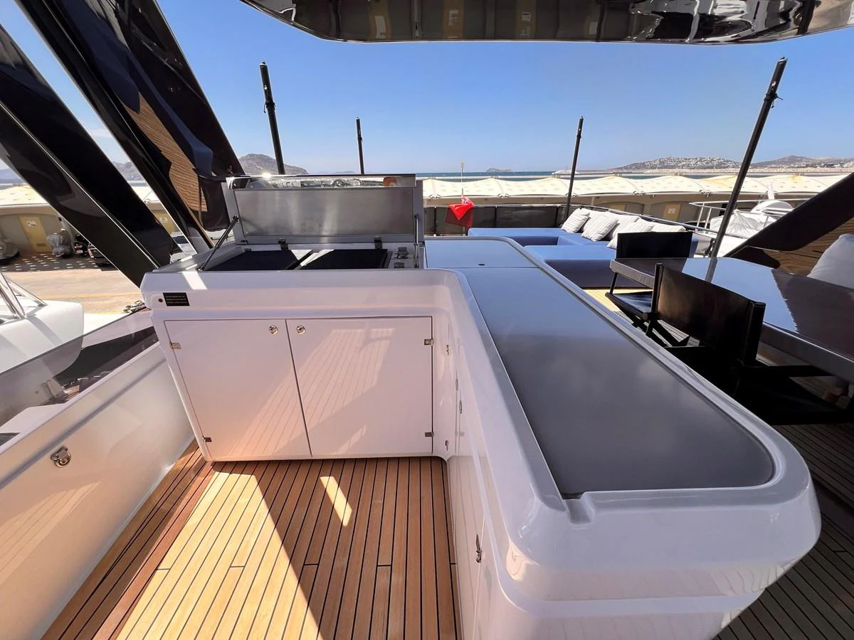 The flybridge features a sleek outdoor kitchen area with modern appliances and ample counter space. aboard LD Yacht for Sale