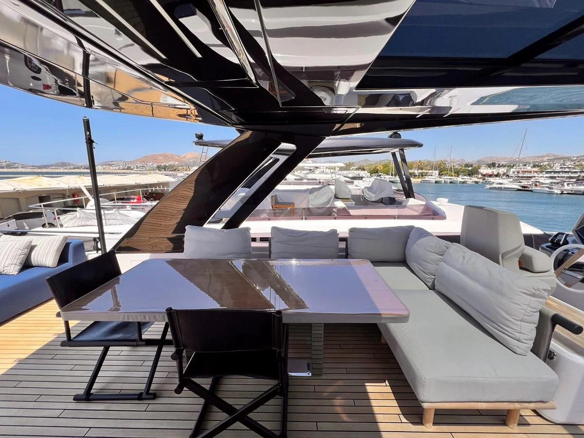 The aft deck offers a stylish and comfortable outdoor dining area with a view of the marina. aboard LD Yacht for Sale