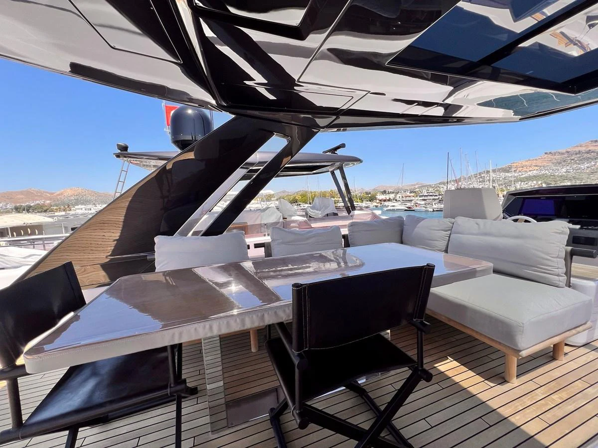 The aft deck features a stylish dining area with comfortable seating and a sleek table, perfect for alfresco meals. aboard LD Yacht for Sale