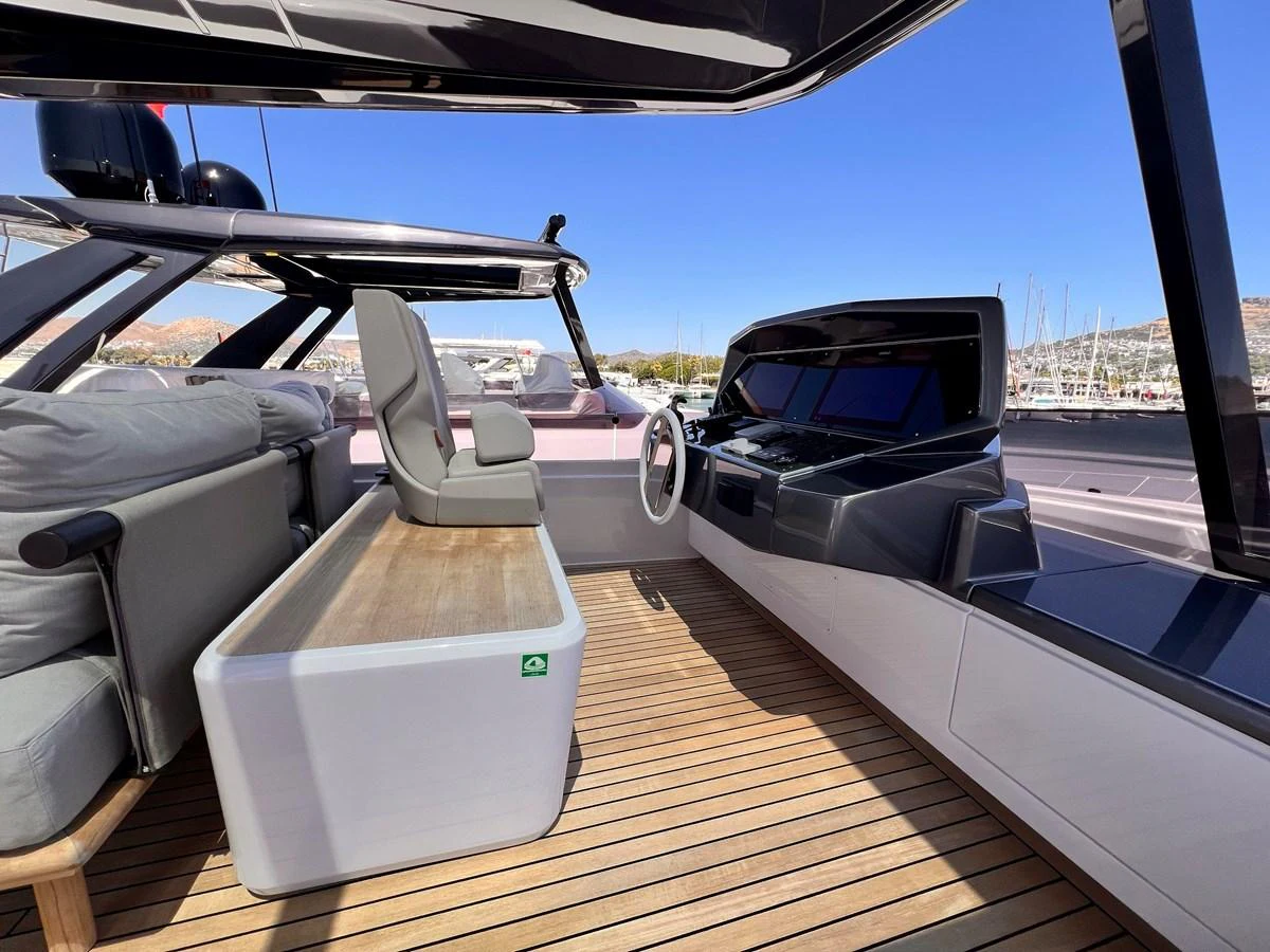 The helm area features modern controls and comfortable seating with a sleek, open design. aboard LD Yacht for Sale