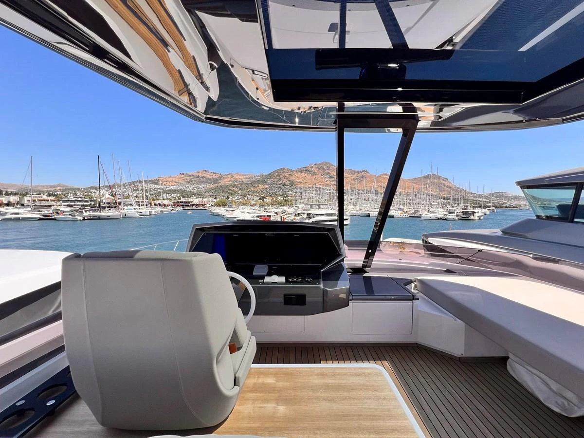 The helm station offers a sleek and modern design with panoramic views of the marina. aboard LD Yacht for Sale