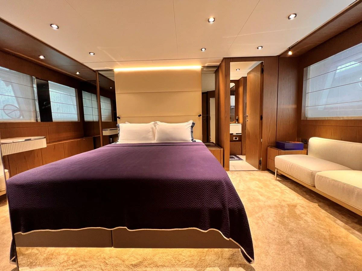 The master stateroom features a luxurious bed with elegant lighting and ample space. aboard LD Yacht for Sale