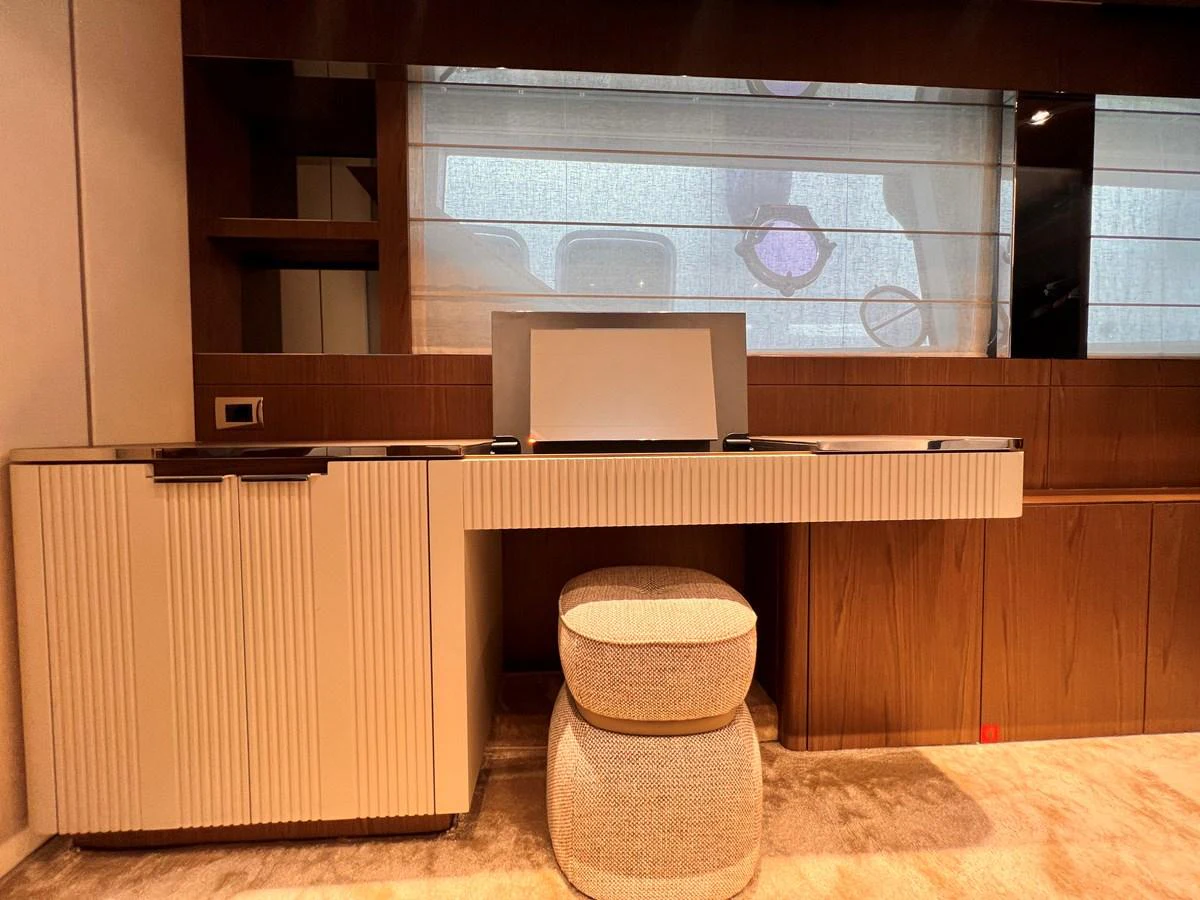 A stylish interior workspace with a modern desk and comfortable stool. aboard LD Yacht for Sale