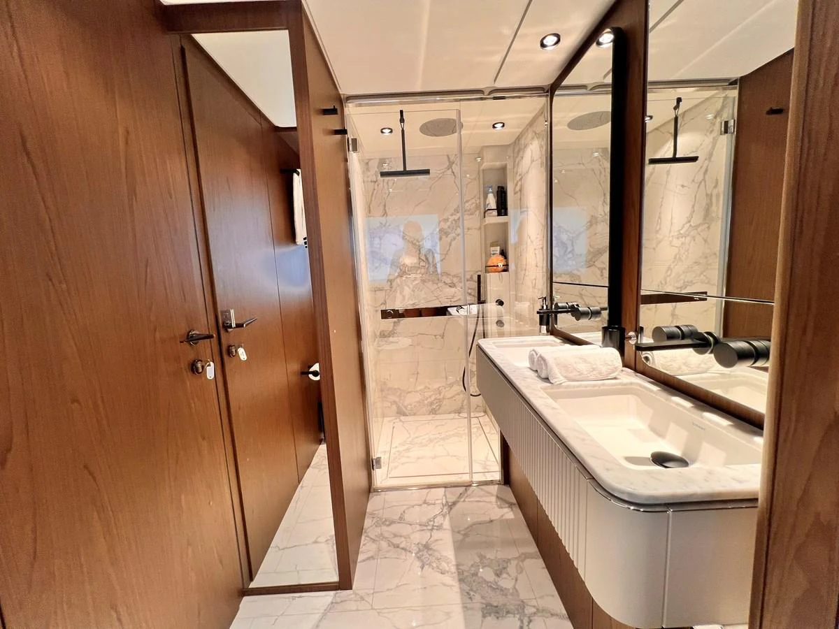 The yacht's bathroom features elegant marble surfaces and modern fixtures. aboard LD Yacht for Sale