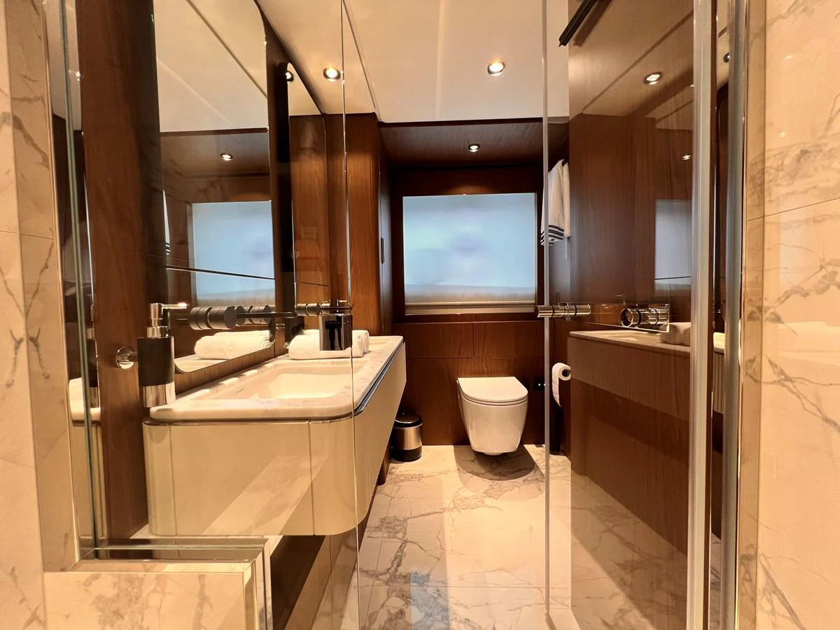 The yacht's bathroom features elegant marble flooring and modern fixtures. aboard LD Yacht for Sale
