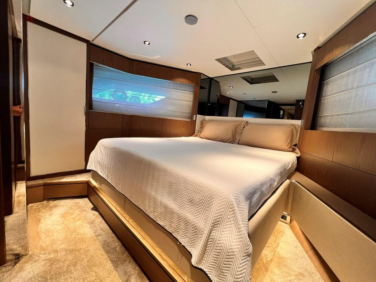 The master stateroom features a spacious bed with elegant bedding and ample natural light. aboard LD Yacht for Sale