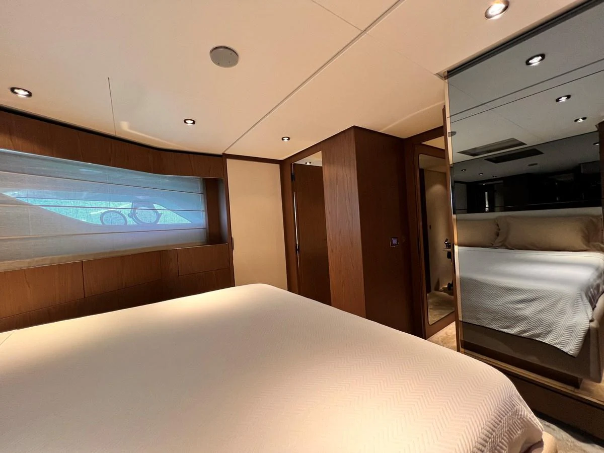 A cozy and elegant stateroom with a large bed and ample natural light. aboard LD Yacht for Sale