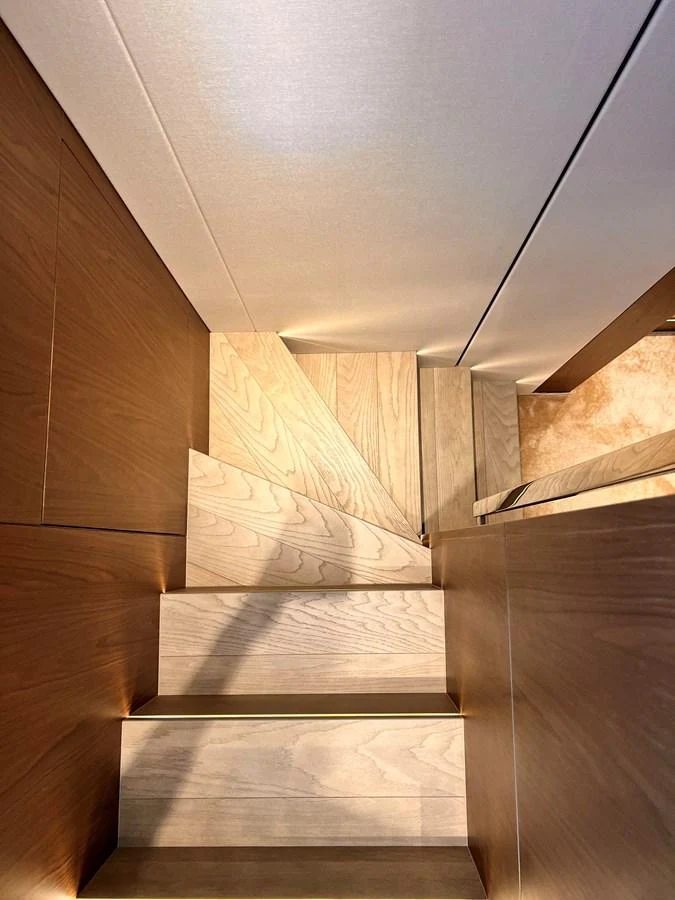 A beautifully crafted wooden staircase inside the yacht. aboard LD Yacht for Sale