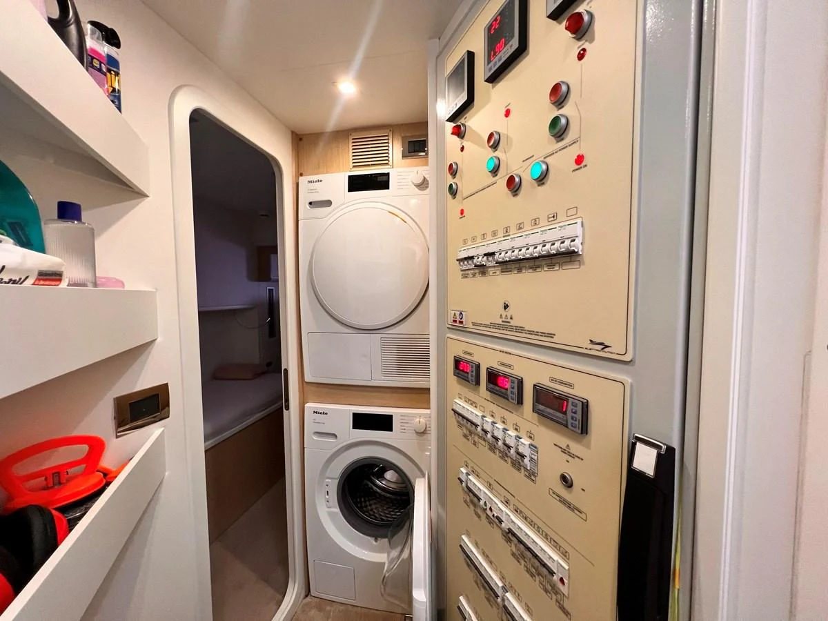The yacht's laundry room features modern appliances and control panels for onboard systems. aboard LD Yacht for Sale