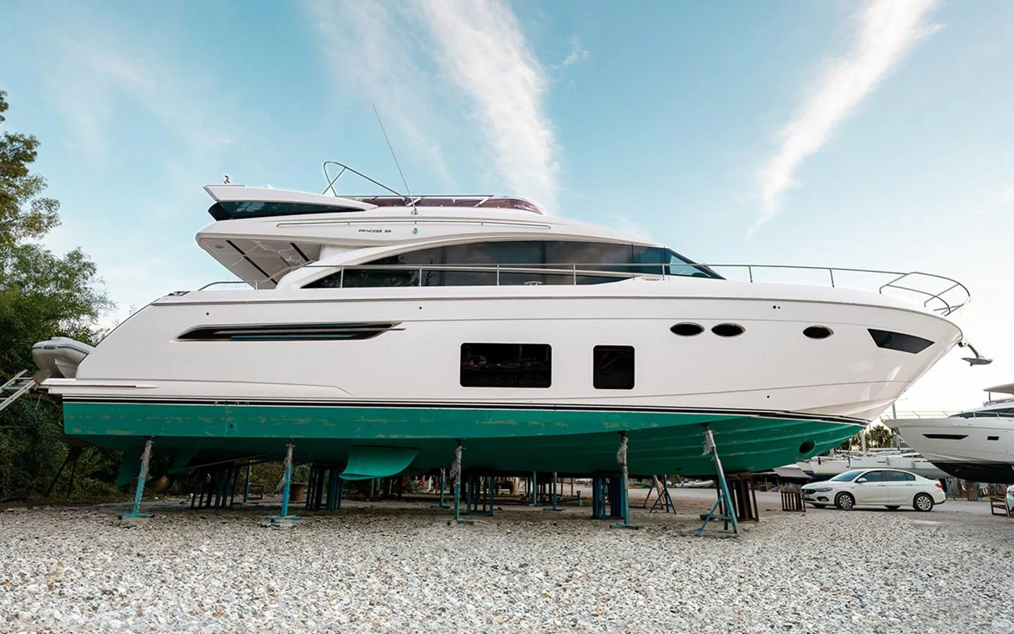 A sleek and modern yacht is showcased on land, highlighting its elegant design and pristine condition. aboard DAPHNE Yacht for Sale
