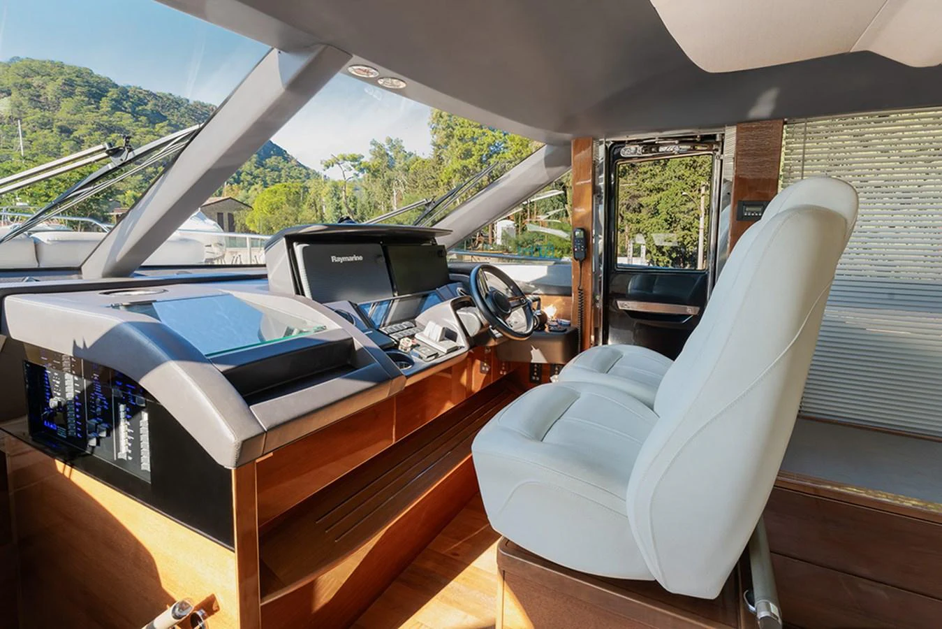 The helm station features modern navigation equipment and a comfortable captain's chair, offering a commanding view for smooth sailing. aboard DAPHNE Yacht for Sale