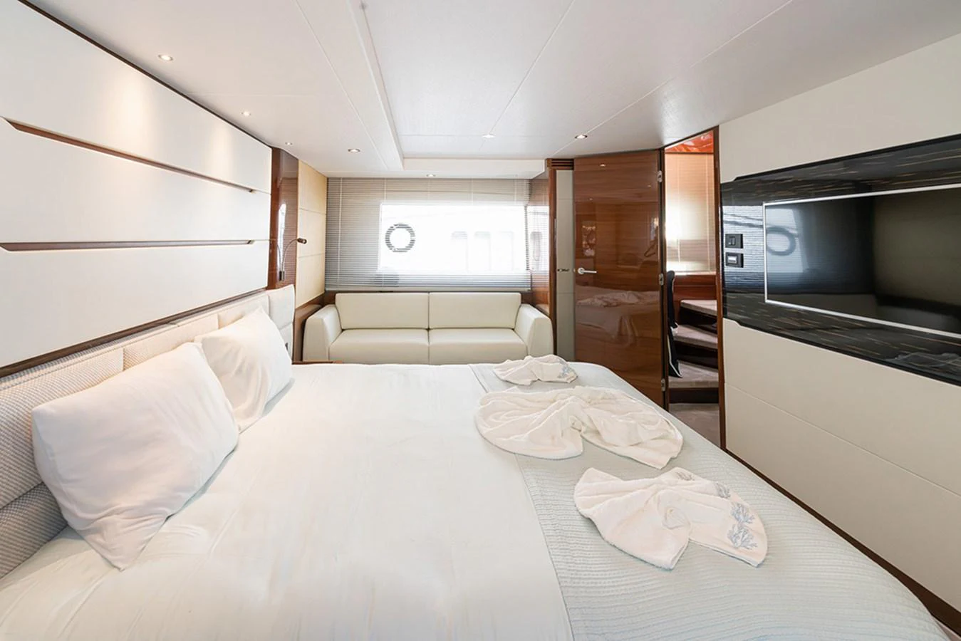 The stateroom features a luxurious bed with plush pillows and a modern design. aboard DAPHNE Yacht for Sale