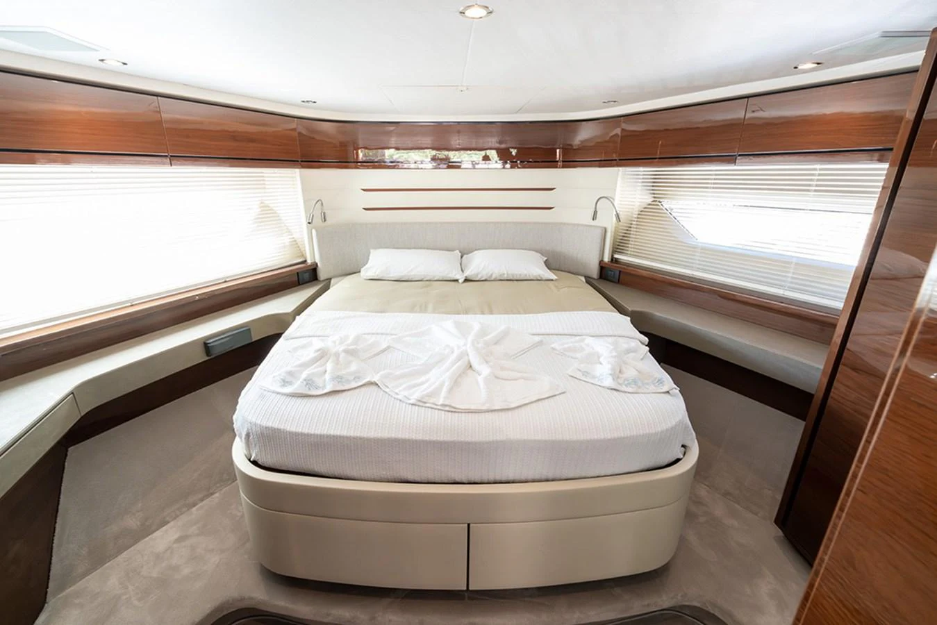 The master stateroom features a luxurious bed with elegant wood paneling and ample natural light. aboard DAPHNE Yacht for Sale