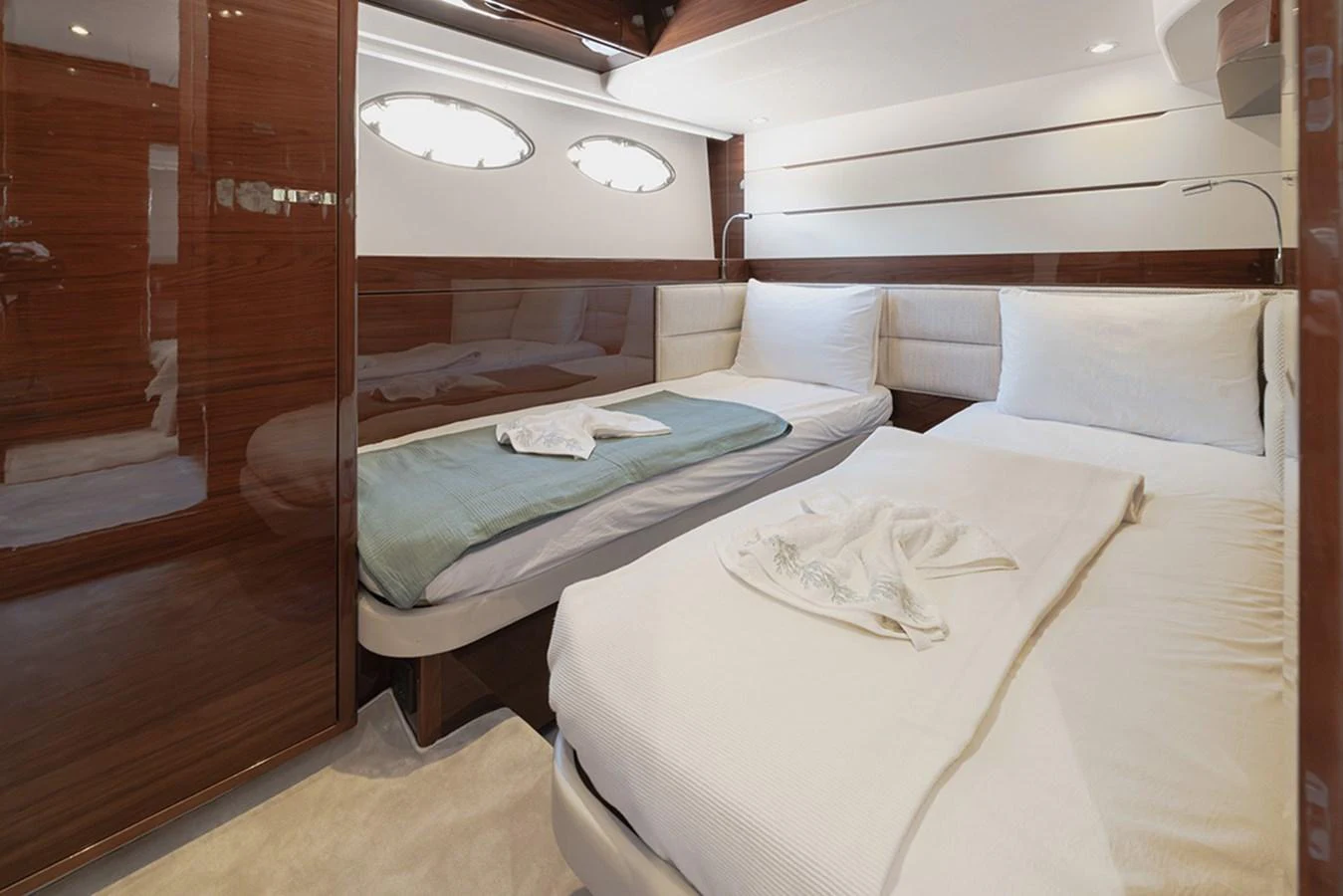 The guest stateroom features twin beds with elegant bedding and polished wood finishes. aboard DAPHNE Yacht for Sale