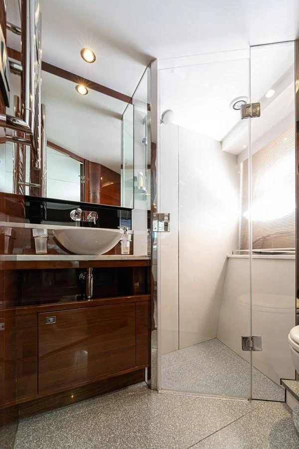 The yacht's bathroom features a modern design with a glass-enclosed shower and sleek fixtures. aboard DAPHNE Yacht for Sale