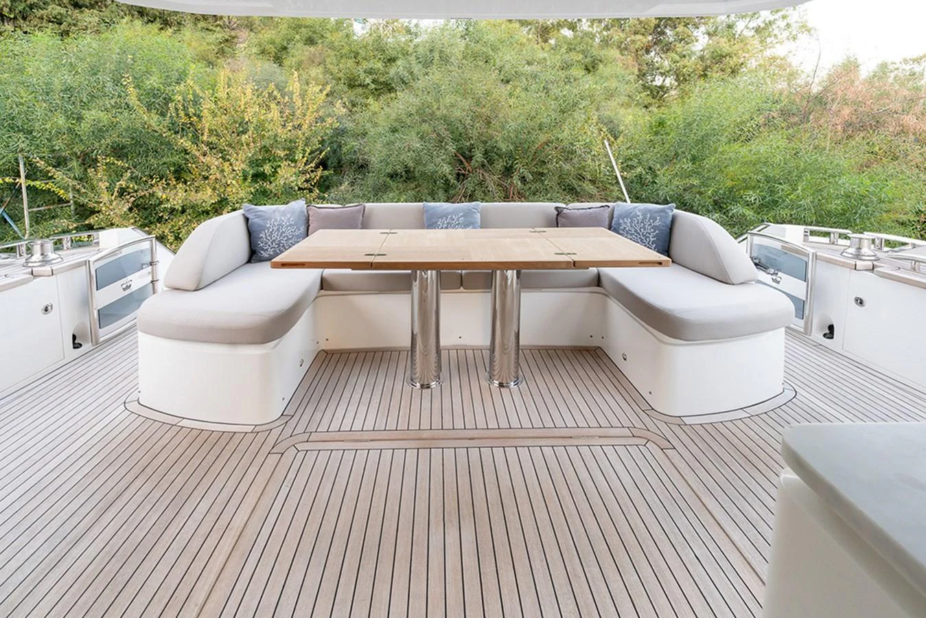 The aft deck features a spacious seating area with a wooden table, perfect for alfresco dining. aboard DAPHNE Yacht for Sale