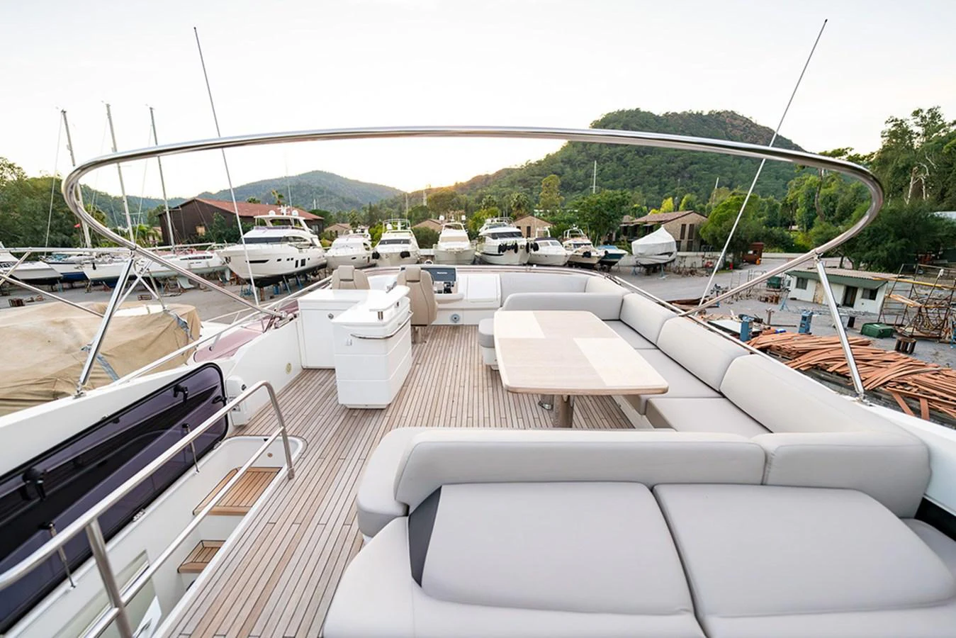 The flybridge offers a spacious and comfortable area for relaxation and dining with a scenic view of the marina. aboard DAPHNE Yacht for Sale