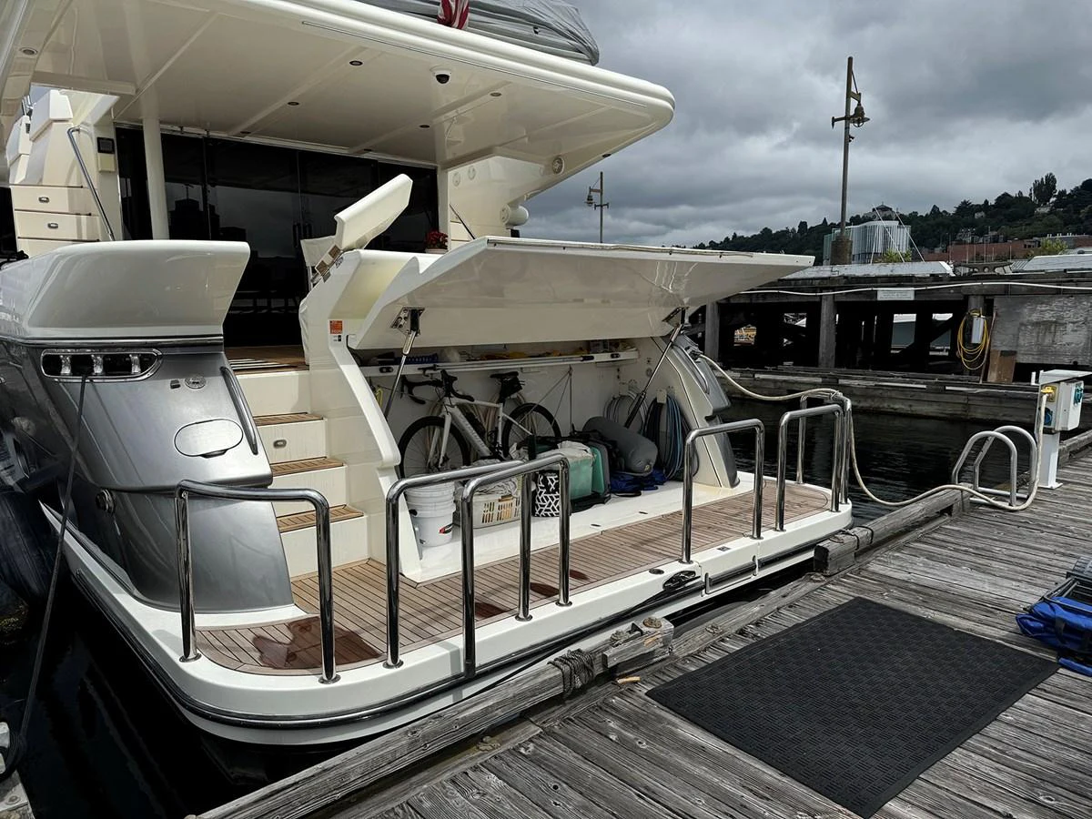 The aft deck features a spacious storage area with bicycles and other equipment, showcasing the yacht's practical amenities. aboard SHOW ME THE MONEY Yacht for Sale