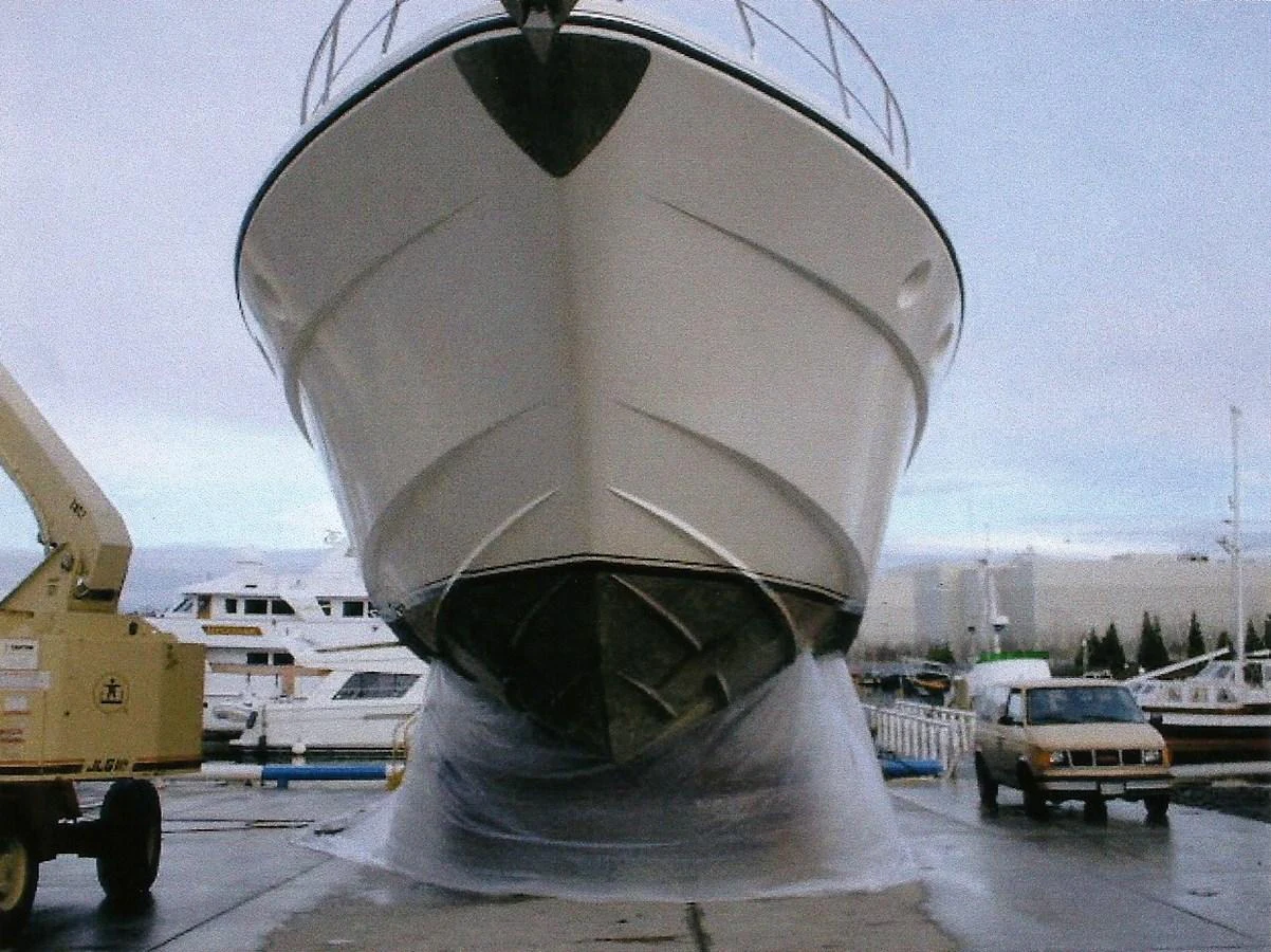 The yacht is seen from the front while on land, showcasing its hull and bow. aboard SHOW ME THE MONEY Yacht for Sale