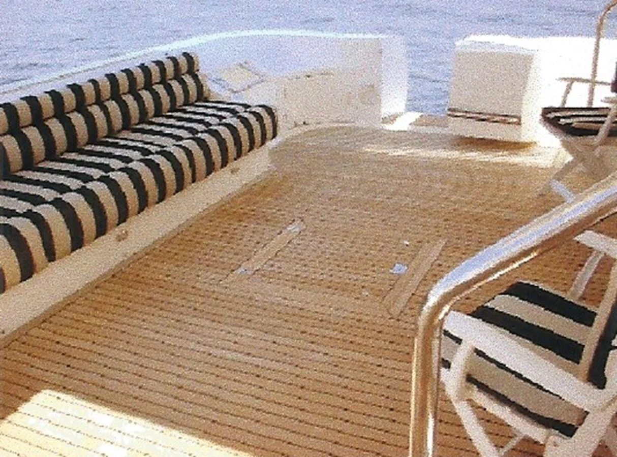 The aft deck features comfortable striped seating and a spacious teak floor, perfect for relaxation. aboard SHOW ME THE MONEY Yacht for Sale