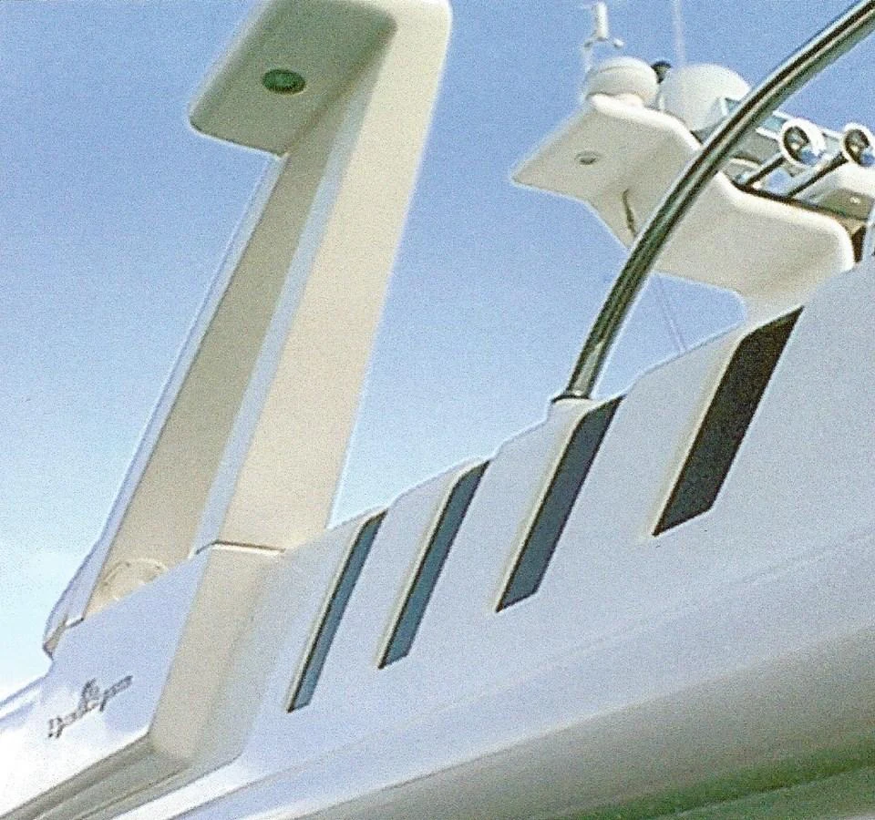 A close-up view of the yacht's sleek radar arch and communication equipment against a clear sky. aboard SHOW ME THE MONEY Yacht for Sale