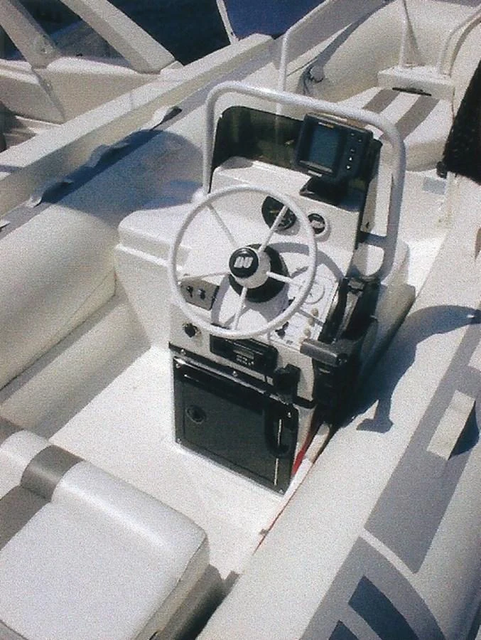 The helm station features a modern steering wheel and navigation equipment. aboard SHOW ME THE MONEY Yacht for Sale