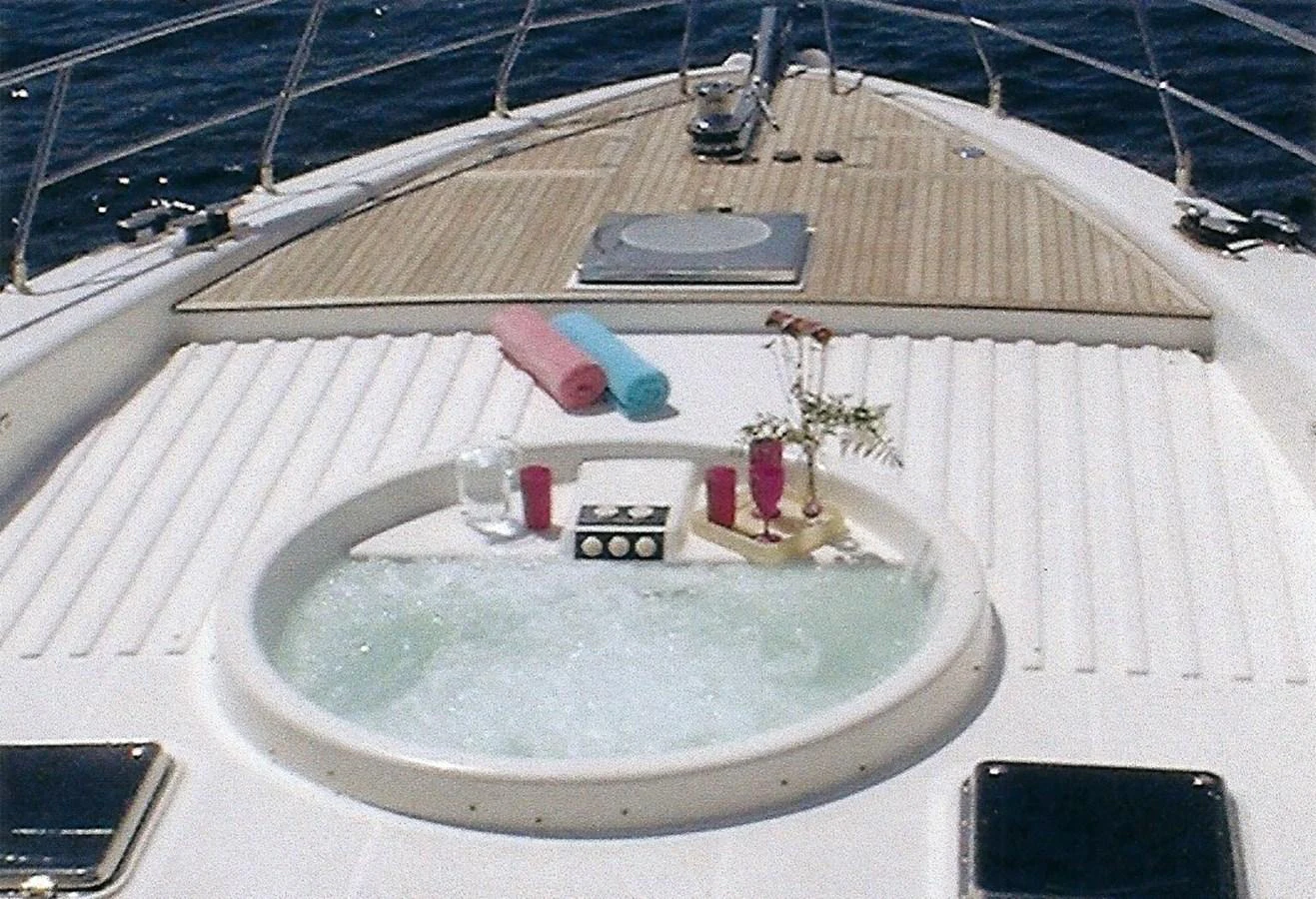 The foredeck features a luxurious jacuzzi with towels and drinks for ultimate relaxation. aboard SHOW ME THE MONEY Yacht for Sale