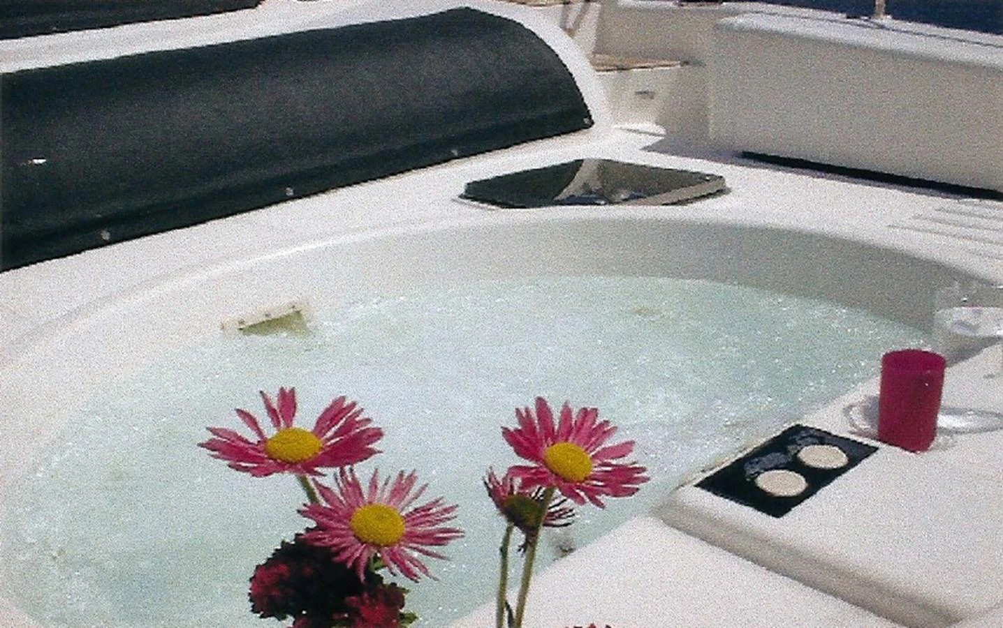 The yacht features a luxurious jacuzzi with fresh flowers adding a touch of elegance. aboard SHOW ME THE MONEY Yacht for Sale