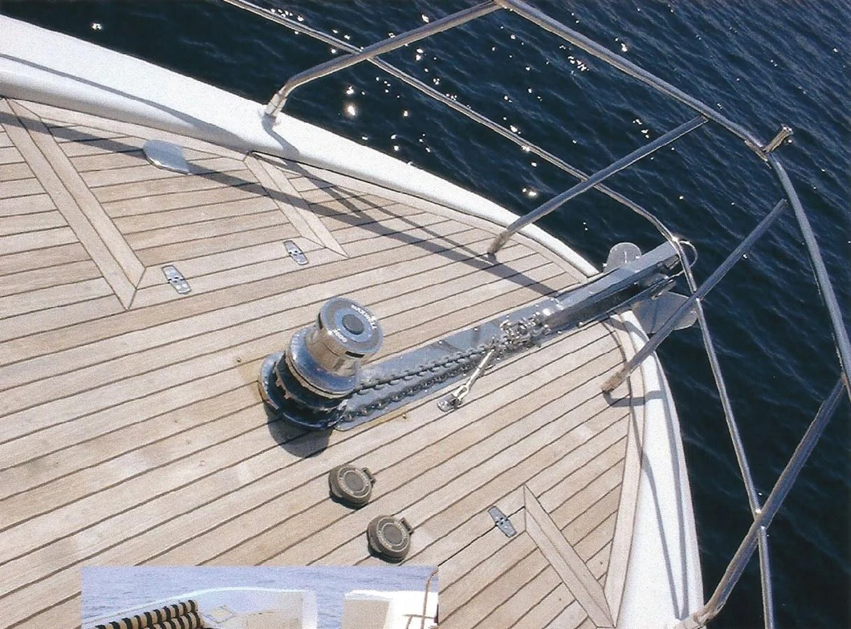 The foredeck features a polished anchor windlass and chain setup, showcasing the yacht's attention to detail. aboard SHOW ME THE MONEY Yacht for Sale