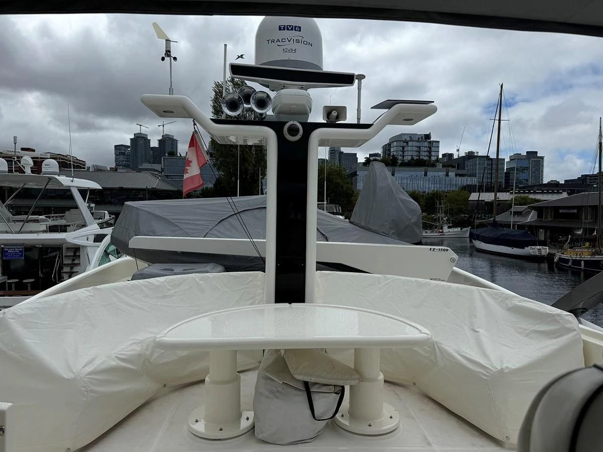 The image showcases the yacht's radar and communication equipment on a cloudy day in the marina. aboard SHOW ME THE MONEY Yacht for Sale