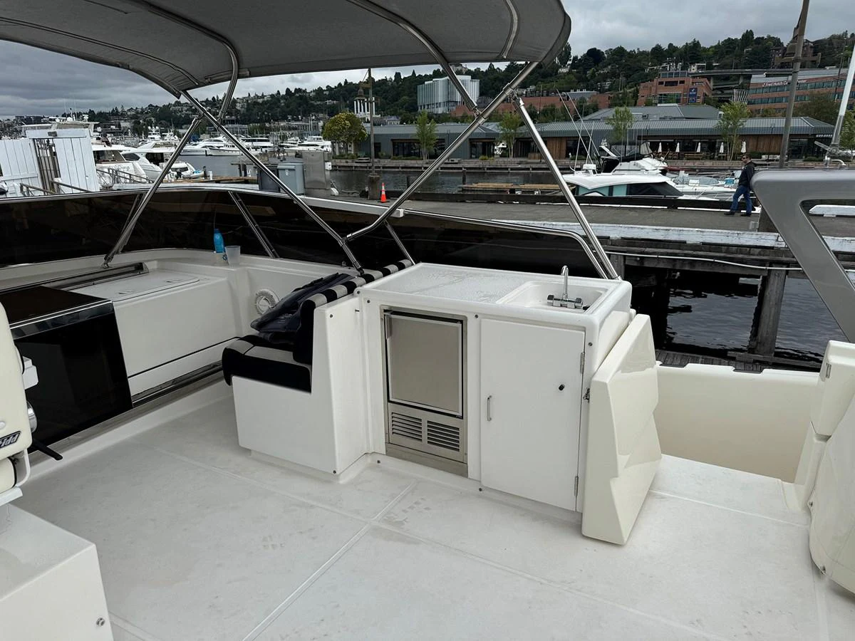The flybridge offers a spacious and functional area with a sink and storage, perfect for outdoor entertaining. aboard SHOW ME THE MONEY Yacht for Sale