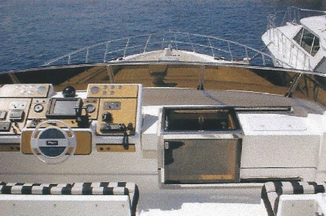 The yacht's helm station offers a commanding view of the open water, featuring advanced navigation equipment and a sleek design. aboard SHOW ME THE MONEY Yacht for Sale