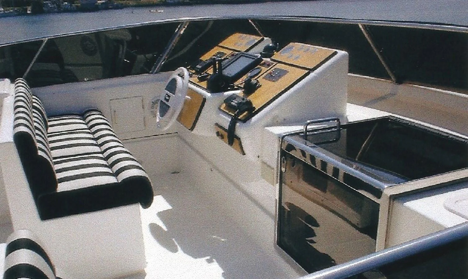 The helm station features a sleek design with modern navigation equipment and comfortable seating. aboard SHOW ME THE MONEY Yacht for Sale