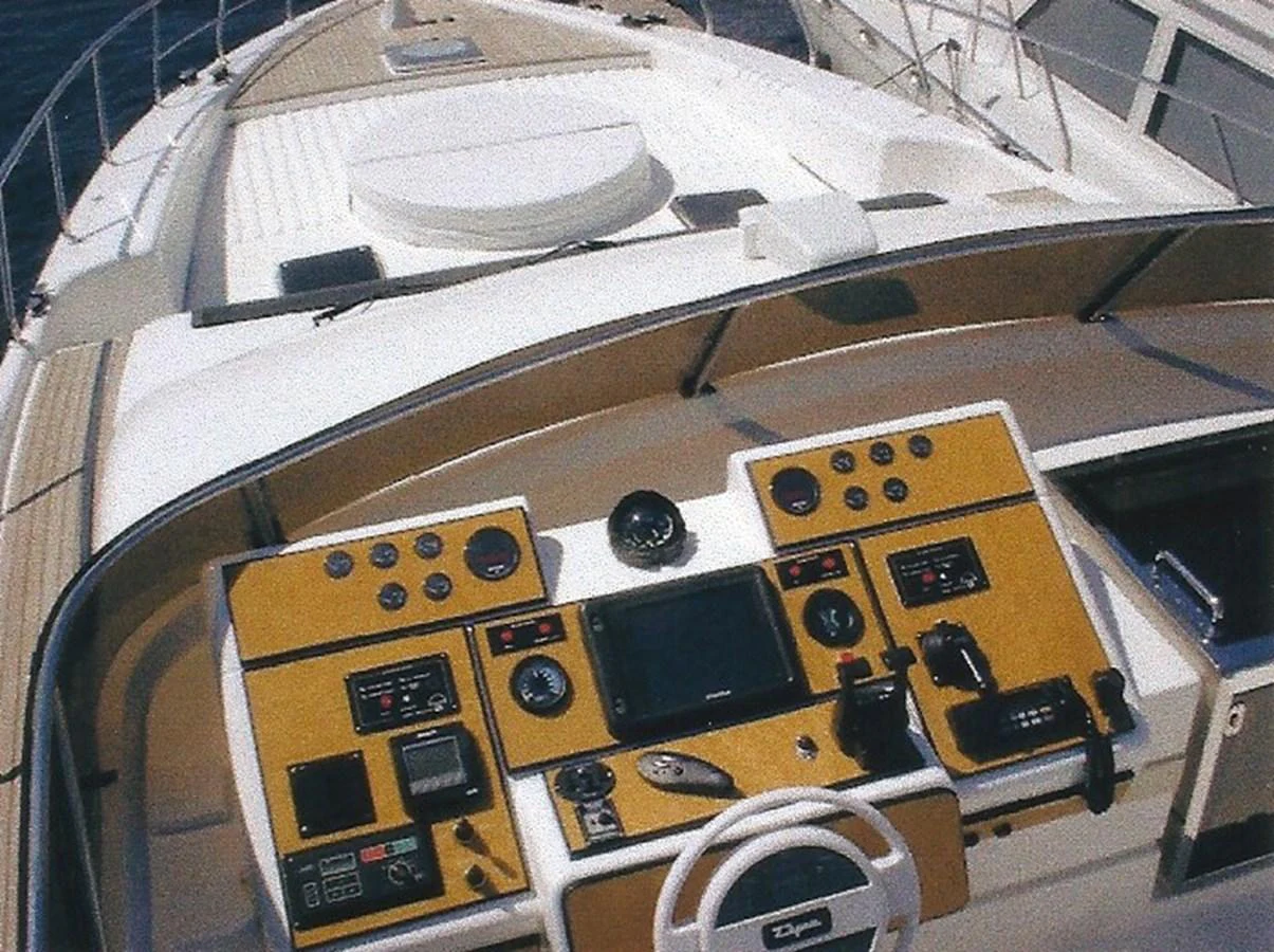The helm station features advanced navigation equipment and a sleek design. aboard SHOW ME THE MONEY Yacht for Sale