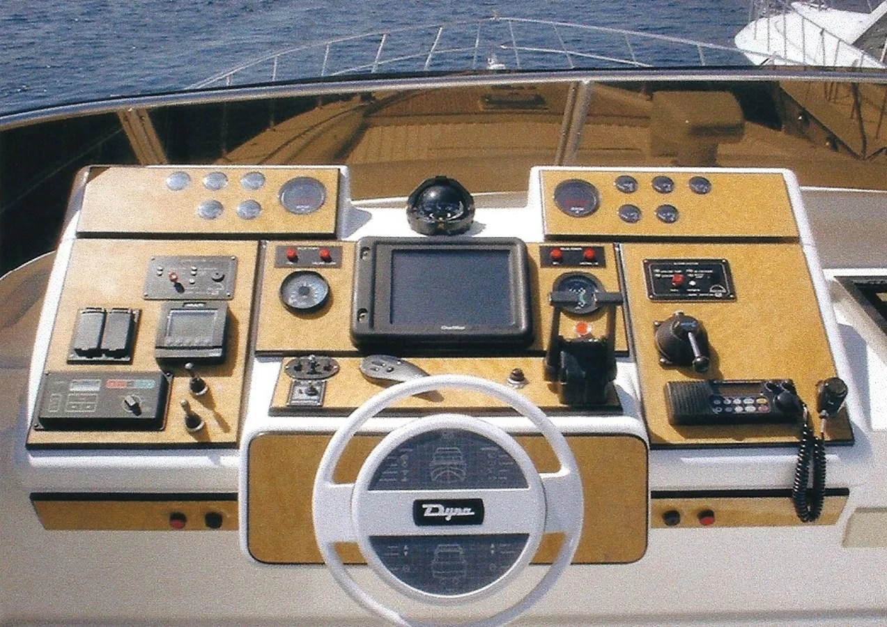 The helm station features advanced navigation and control systems with a sleek design. aboard SHOW ME THE MONEY Yacht for Sale