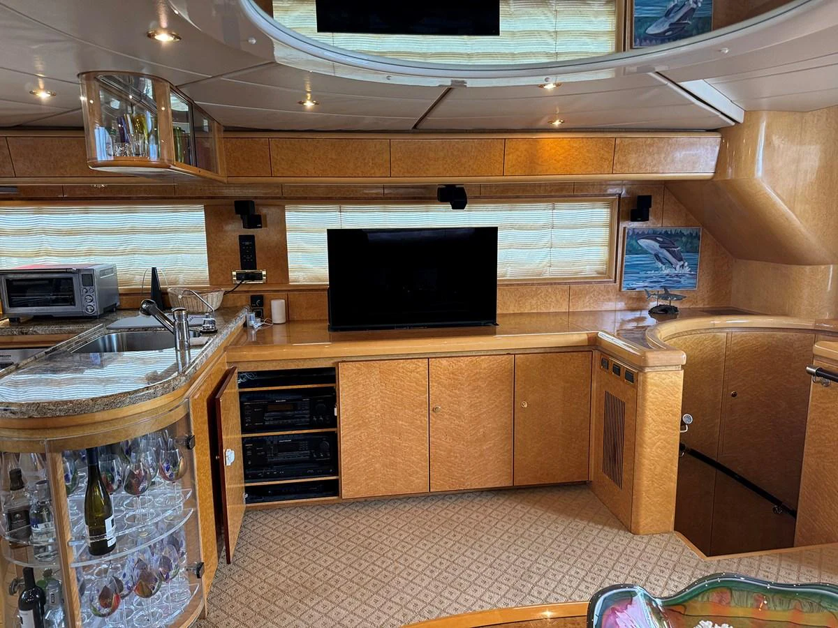 The salon features a well-equipped entertainment center and a stylish bar area. aboard SHOW ME THE MONEY Yacht for Sale