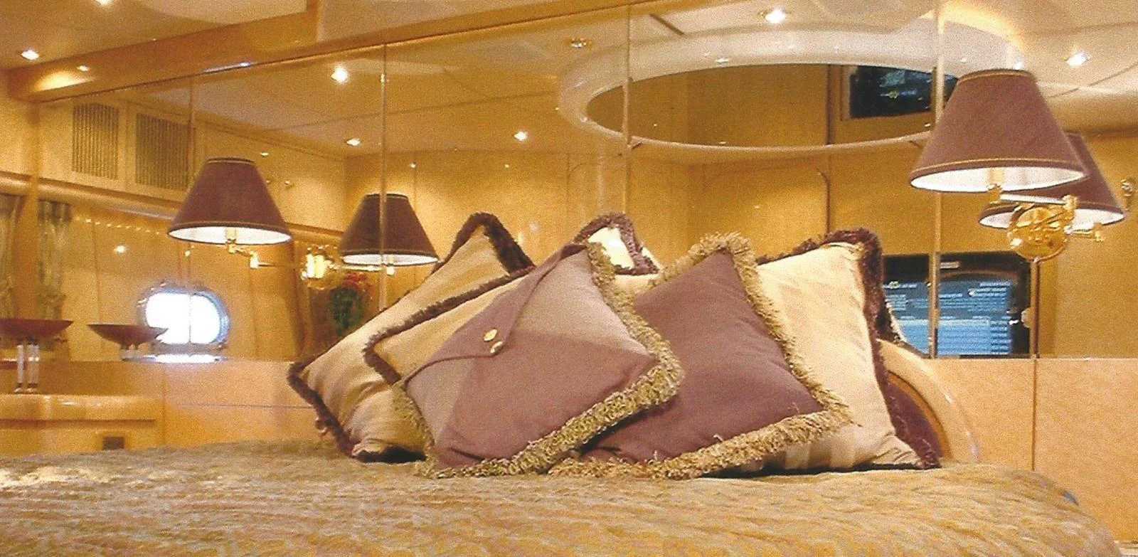 The stateroom features luxurious bedding and elegant lighting, creating a warm and inviting atmosphere. aboard SHOW ME THE MONEY Yacht for Sale