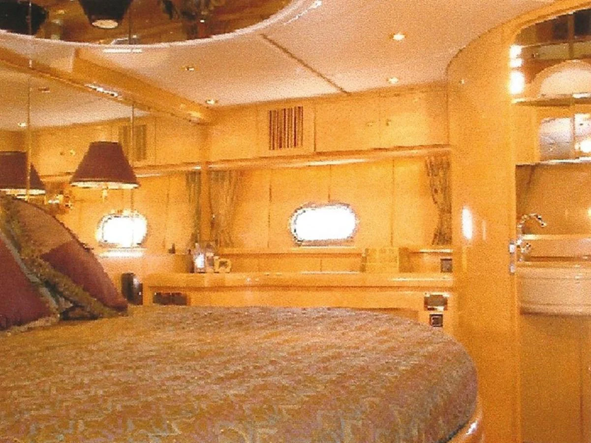 The stateroom features luxurious bedding and warm, ambient lighting. aboard SHOW ME THE MONEY Yacht for Sale